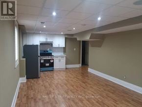 Vaughan (Sonoma Heights) apartment for rent - A kitchen area with a refrigerator, cabinets, and a countertop.