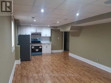 Vaughan (Sonoma Heights) apartment for rent - A kitchen area with a refrigerator, cabinets, and a countertop.