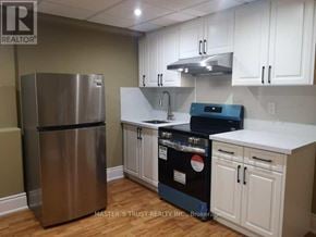 Vaughan (Sonoma Heights) apartment for rent - A kitchen with a stainless steel refrigerator, a stove, and white cabinets.