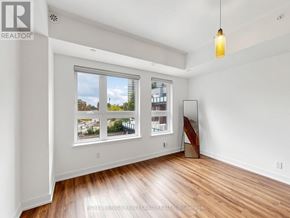 Toronto (L'amoreaux) townhouse for rent - A room with a large window and wooden flooring.