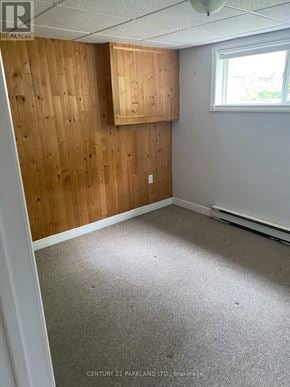 King (King City) apartment for rent - A room with wooden walls and a window.