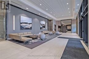 Markham (Unionville) condo for rent - A modern living room with a large couch and a rug.