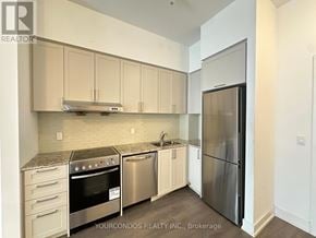 Markham (Unionville) condo for rent - A kitchen with a stainless steel refrigerator, oven, and sink.