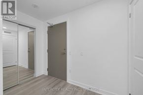 Brampton (Bram East) condo for rent - A room with a white door and a mirror on the wall.