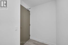 Brampton (Bram East) condo for rent - A room with a white wall and a brown door.