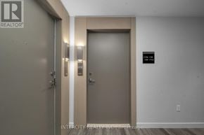 Brampton (Bram East) condo for rent - A hallway with a door and a sign on the wall.