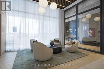 Brampton (Bram East) condo for rent - A modern living room with white furniture and a glass door leading to a balcony.