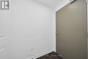 Brampton (Bram East) condo for rent - A room with a white wall and a brown door.