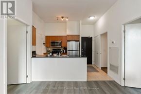Toronto (Niagara) condo for rent - A modern kitchen with white cabinets and a white island.