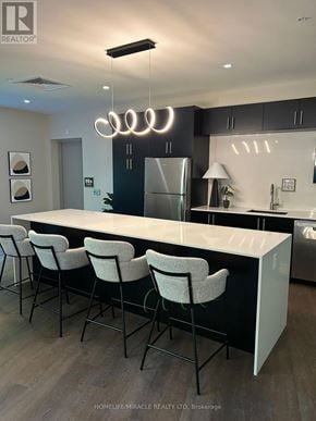 Kitchener house for rent - A modern kitchen with a bar area and chairs.