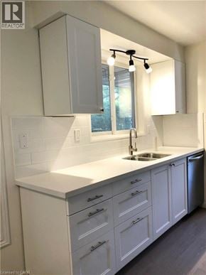 Hamilton apartment for rent - A kitchen with white cabinets and a window above the sink.