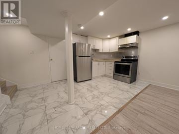 Brampton (Fletcher's West) apartment for rent - A kitchen with white cabinets and a marble floor.