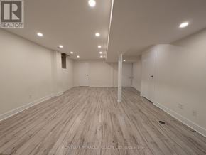 Brampton (Fletcher's West) apartment for rent - A spacious room with wooden flooring and white walls.