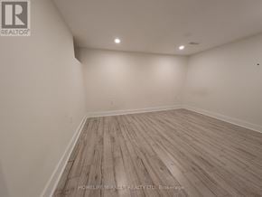 Brampton (Fletcher's West) apartment for rent - A room with wooden flooring and white walls.