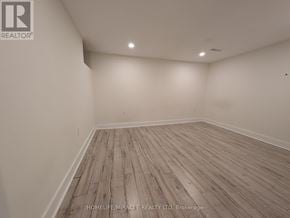 Brampton (Fletcher's West) apartment for rent - A room with wooden flooring and white walls.