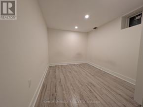 Brampton (Fletcher's West) apartment for rent - A room with wooden flooring and white walls.