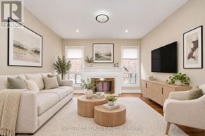 Markham (Markville) apartment for rent - A living room with a fireplace, a couch, a chair, and a television.