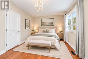 Markham (Markville) apartment for rent - A bedroom with a large bed and a chandelier.