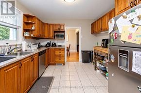 Ottawa apartment for rent - A kitchen with wooden cabinets and a refrigerator covered in notes.