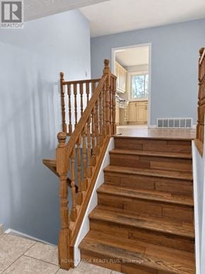 Hamilton (Binbrook) apartment for rent - A wooden staircase with a white railing.