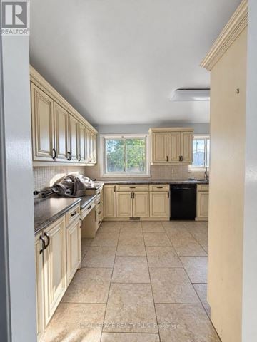 Hamilton (Binbrook) apartment for rent - A kitchen with beige cabinets and a black trash can.