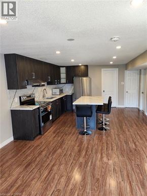 Breslau apartment for rent - A kitchen with dark wood floors and white walls.
