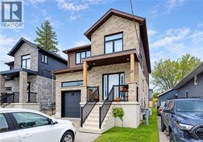 Kitchener apartment for rent - A modern two-story house with a white car parked in front.