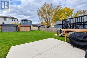 Kitchener apartment for rent - A backyard with a concrete patio and a black grill.