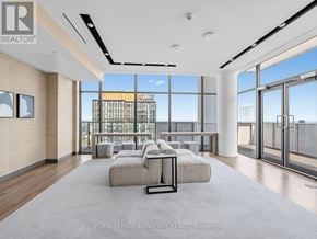 Toronto (Church-Yonge Corridor) condo for rent - A spacious living room with a view of the cityscape outside the large windows.