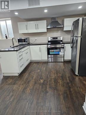 Milton (Sc Scott) apartment for rent - A kitchen with white cabinets and a black fridge.