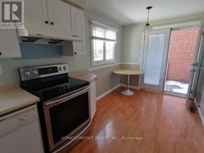 Toronto (L'amoreaux) apartment for rent - A kitchen with a black stove top oven and white cabinets.