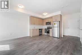 Mississauga (Erin Mills) townhouse for rent - A spacious kitchen with wooden cabinets and stainless steel appliances.
