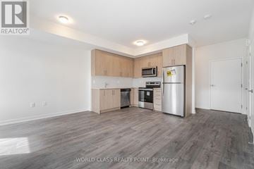 Mississauga (Erin Mills) townhouse for rent - A spacious kitchen with wooden cabinets and stainless steel appliances.