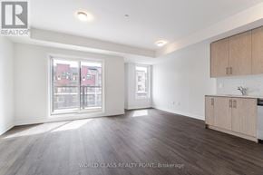 Mississauga (Erin Mills) townhouse for rent - A spacious room with wooden flooring and a large window overlooking a street.