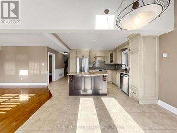 Mississauga (Central Erin Mills) apartment for rent - A spacious kitchen with a center island and modern appliances.