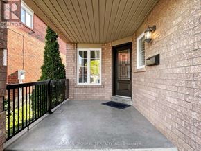 Mississauga (Central Erin Mills) apartment for rent - A front porch with a black railing and a brick wall.