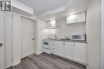 Ottawa apartment for rent - A kitchen with white cabinets and appliances.