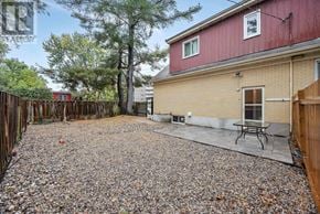 Ottawa apartment for rent - A backyard with a gravel patio and a picnic table.