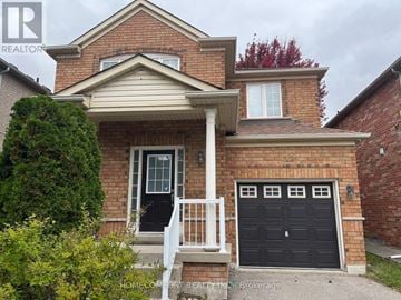 Vaughan (Vellore Village) apartment for rent - A brick house with a black front door and a garage door.