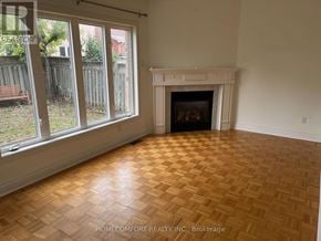 Vaughan (Vellore Village) apartment for rent - A room with a fireplace and a wooden floor.