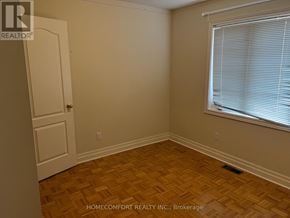 Vaughan (Vellore Village) apartment for rent - A room with wooden flooring and a window with blinds.