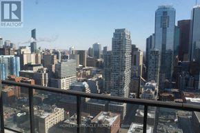 Toronto (Waterfront Communities) condo for rent - A cityscape with a clear sky and buildings of various heights.