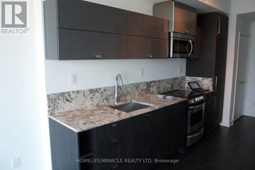 Toronto (Waterfront Communities) condo for rent - A kitchen with a marble countertop and stainless steel appliances.