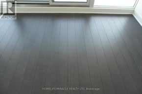 Toronto (Waterfront Communities) condo for rent - A room with a wooden floor and a window.