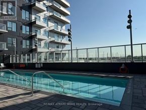Vaughan (Vaughan Corporate Centre) condo for rent - A pool is located outside of a building with the words RE/MAX Atrum Home Realty, Brokerage written on the ground.