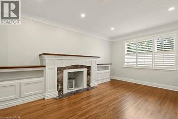 Burlington apartment for rent - A room with a fireplace and wooden floors.