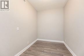 Mississauga (Clarkson) condo for rent - A room with a wooden floor and white walls.