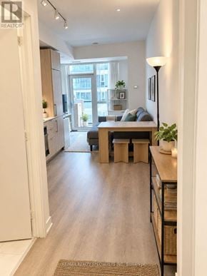 Toronto (Niagara) condo for rent - A well-lit, modern living room with a large window and a view of the city.