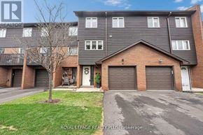Mississauga (Rathwood) townhouse for rent - A building with a tree in front and a sign that says Royal LePage Realty Plus Brokerage.