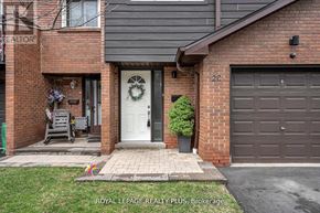 Mississauga (Rathwood) townhouse for rent - A house with a white door and a garage door is shown.